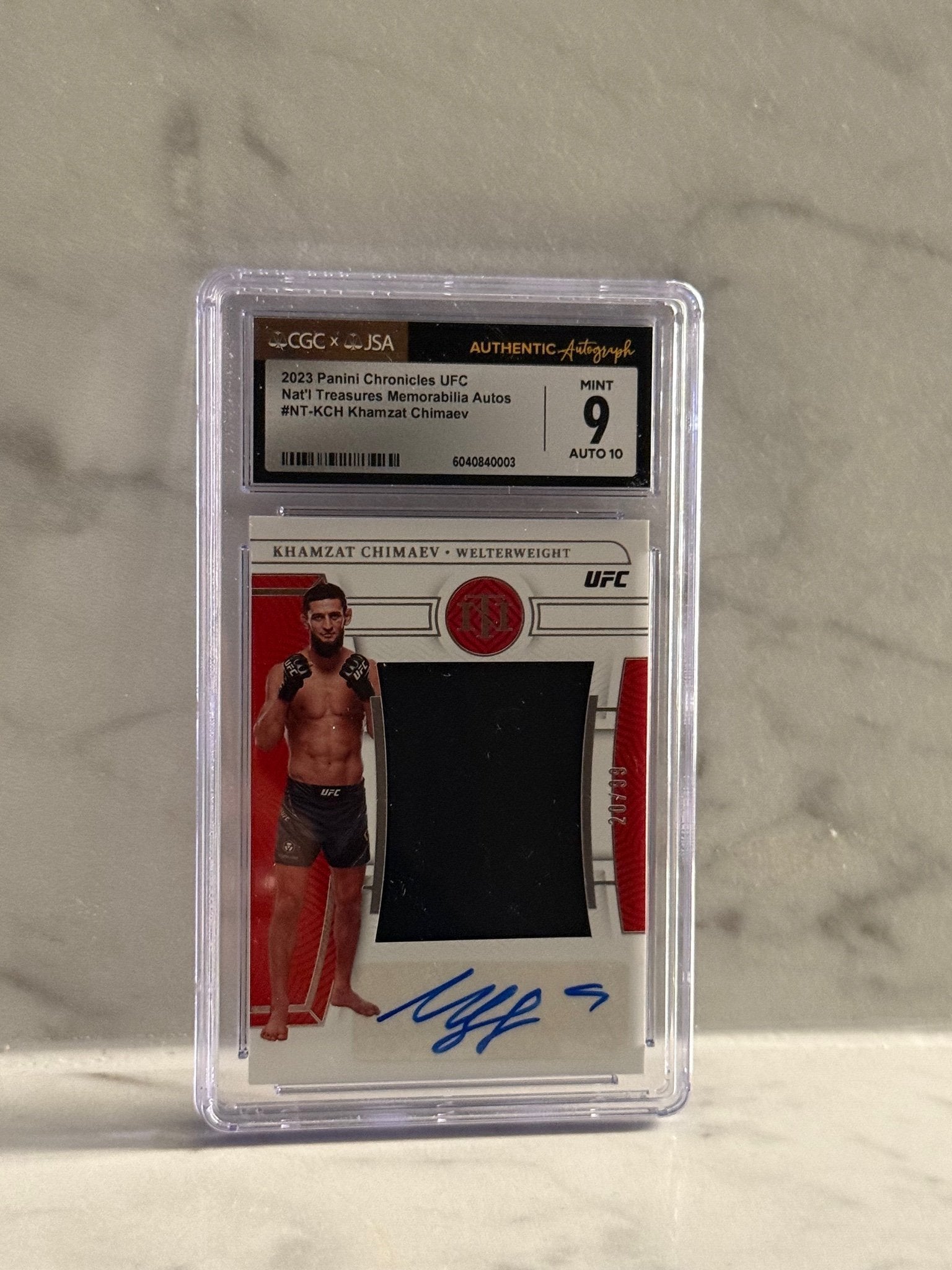 2023 Panini Chronicles UFC – Khamzat Chimaev National Treasures Patch Auto #/99 – Rookie Hit